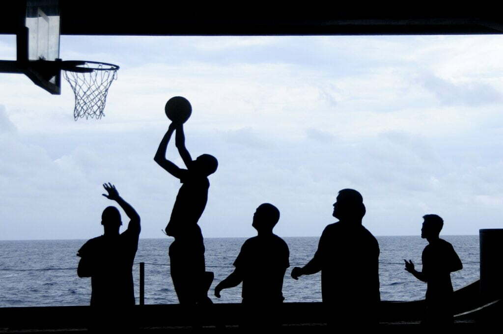 People playing basketball by the water